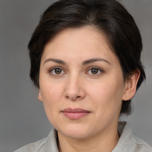 Joyful white adult female with medium  brown hair and brown eyes