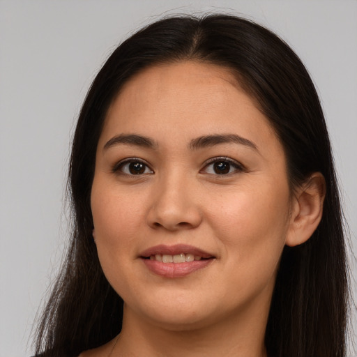 Joyful white young-adult female with long  brown hair and brown eyes