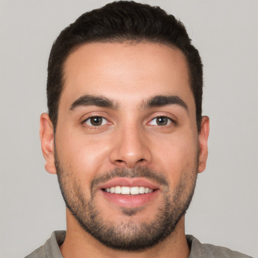 Joyful white young-adult male with short  brown hair and brown eyes