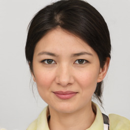 Joyful asian young-adult female with medium  brown hair and brown eyes