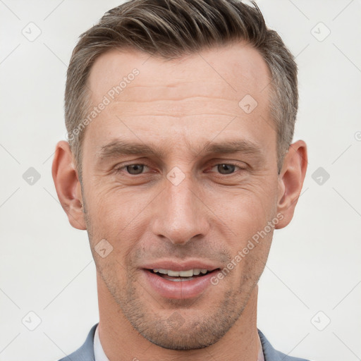 Joyful white adult male with short  brown hair and grey eyes