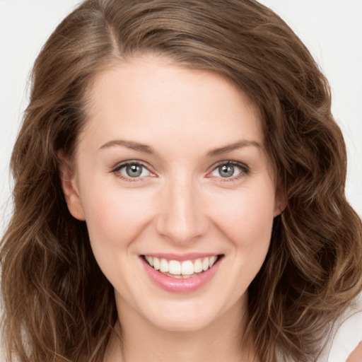 Joyful white young-adult female with long  brown hair and green eyes