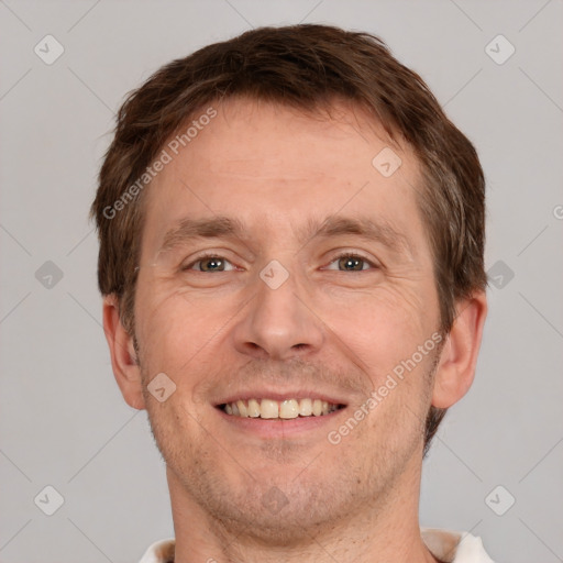 Joyful white adult male with short  brown hair and grey eyes