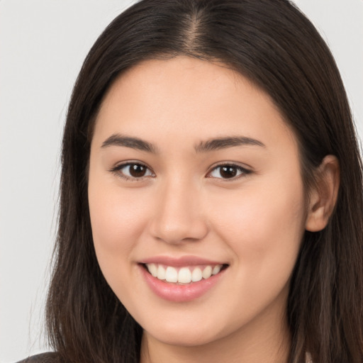 Joyful white young-adult female with long  brown hair and brown eyes