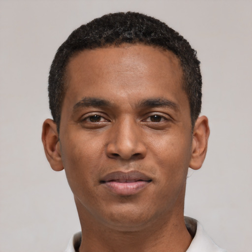 Joyful black young-adult male with short  black hair and brown eyes