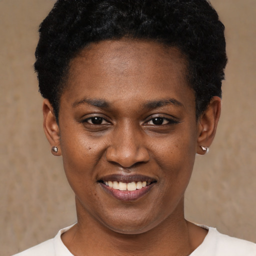 Joyful black young-adult female with short  black hair and brown eyes