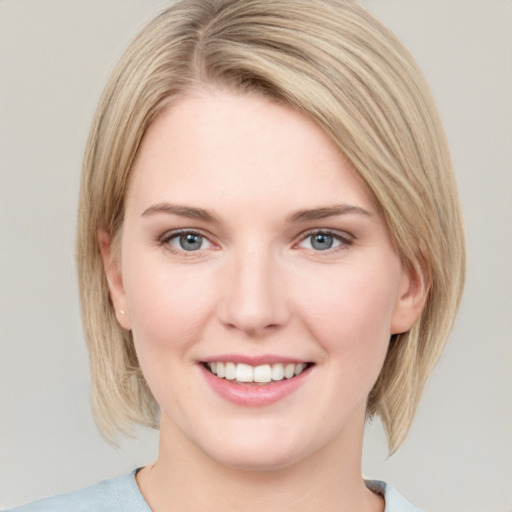 Joyful white young-adult female with medium  brown hair and blue eyes