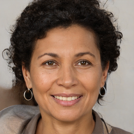 Joyful white adult female with short  brown hair and brown eyes