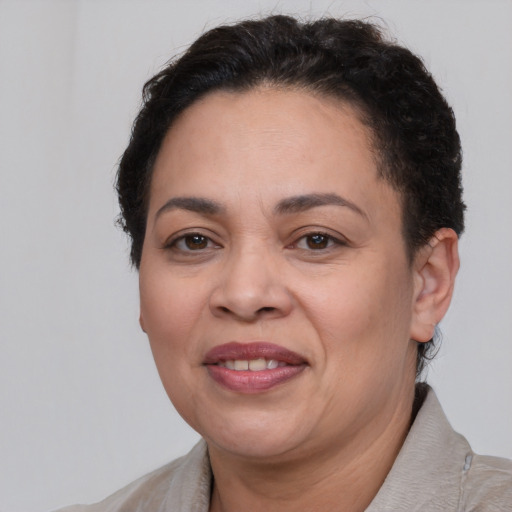 Joyful latino adult female with short  brown hair and brown eyes