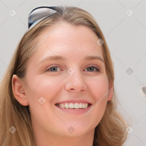 Joyful white young-adult female with long  brown hair and blue eyes