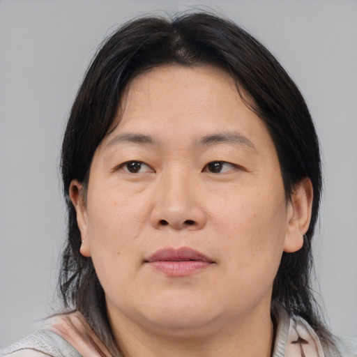 Joyful asian adult female with medium  brown hair and brown eyes