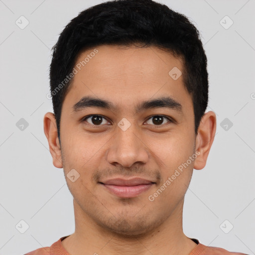 Joyful latino young-adult male with short  black hair and brown eyes