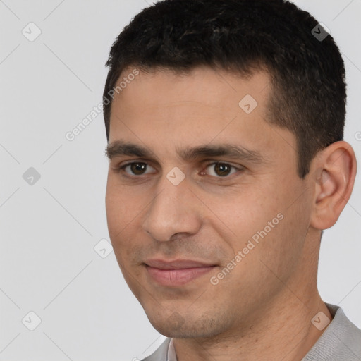 Joyful white young-adult male with short  black hair and brown eyes