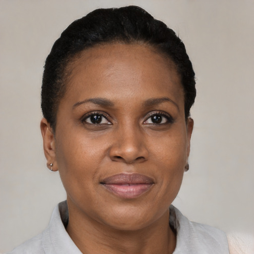 Joyful black adult female with short  brown hair and brown eyes