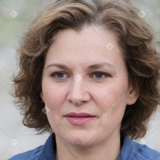 Joyful white adult female with medium  brown hair and blue eyes