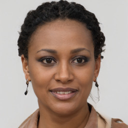 Joyful black young-adult female with short  brown hair and brown eyes