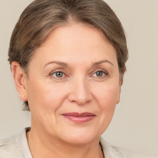 Joyful white adult female with short  brown hair and grey eyes