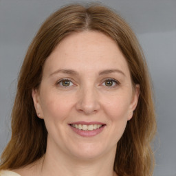 Joyful white adult female with medium  brown hair and grey eyes