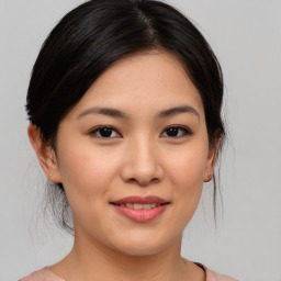 Joyful asian young-adult female with medium  brown hair and brown eyes