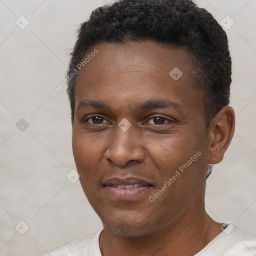 Joyful black young-adult male with short  black hair and brown eyes