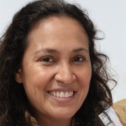 Joyful white adult female with long  brown hair and brown eyes