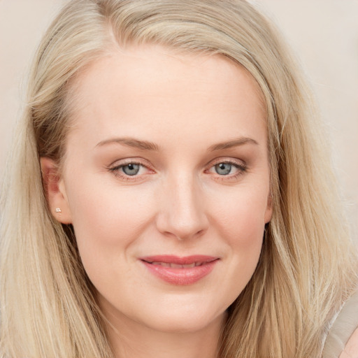 Joyful white young-adult female with long  brown hair and blue eyes