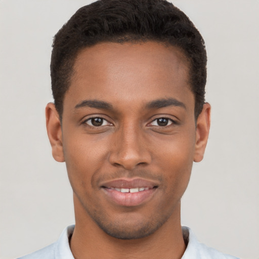 Joyful black young-adult male with short  brown hair and brown eyes