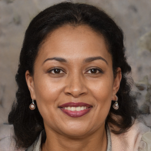 Joyful latino adult female with medium  brown hair and brown eyes