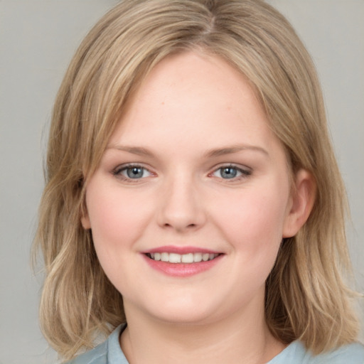 Joyful white young-adult female with medium  brown hair and blue eyes