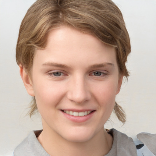 Joyful white young-adult female with medium  brown hair and grey eyes