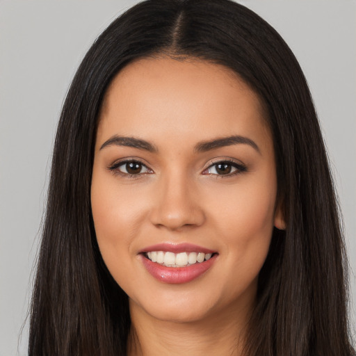 Joyful latino young-adult female with long  black hair and brown eyes