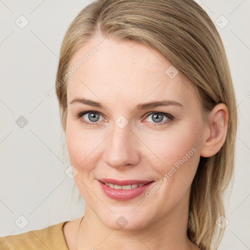 Joyful white young-adult female with medium  brown hair and blue eyes