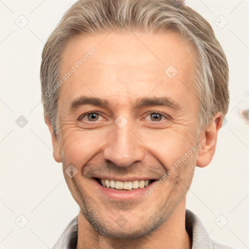 Joyful white adult male with short  brown hair and brown eyes