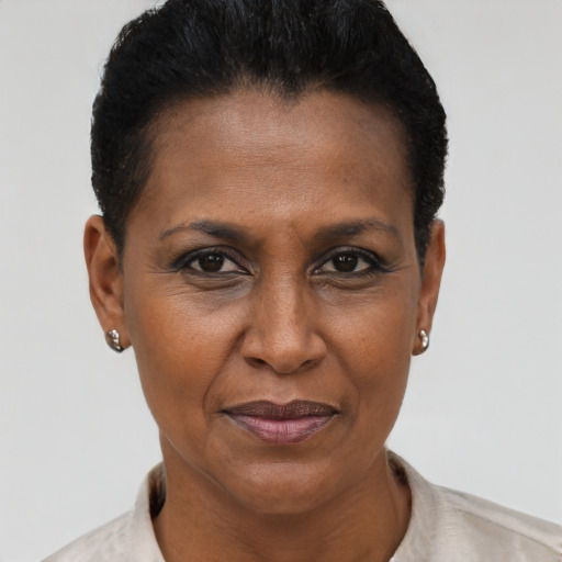 Joyful black adult female with short  brown hair and brown eyes