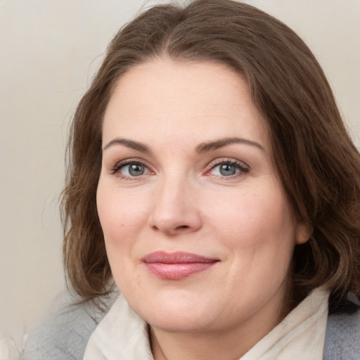 Joyful white young-adult female with medium  brown hair and green eyes