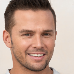 Joyful white young-adult male with short  brown hair and brown eyes