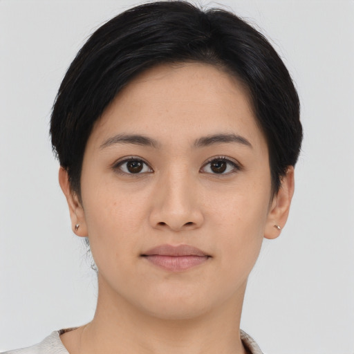 Joyful asian young-adult female with short  brown hair and brown eyes
