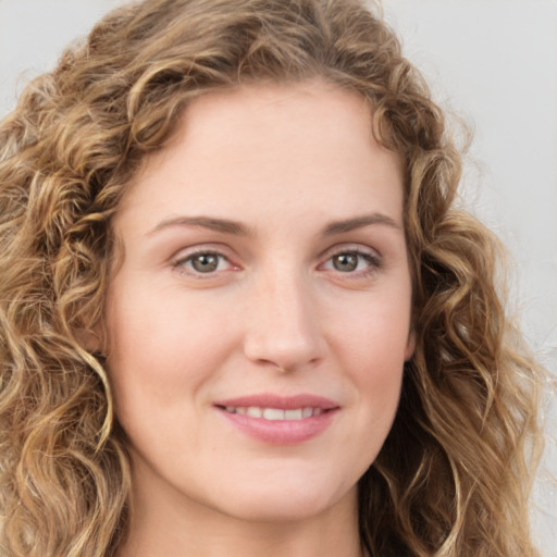 Joyful white young-adult female with long  brown hair and green eyes