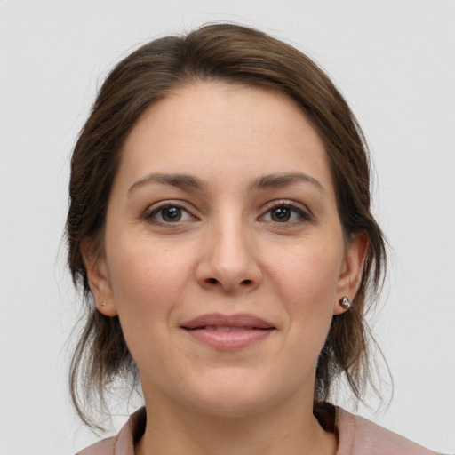 Joyful white young-adult female with medium  brown hair and brown eyes