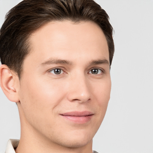 Joyful white young-adult male with short  brown hair and brown eyes