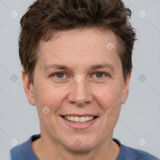 Joyful white adult male with short  brown hair and grey eyes