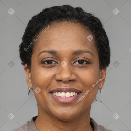 Joyful black young-adult female with short  brown hair and brown eyes