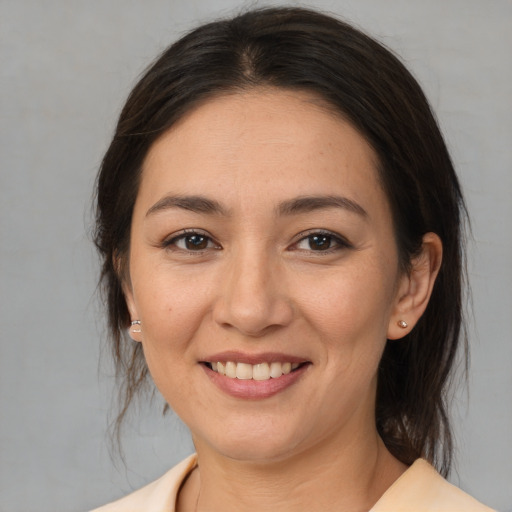 Joyful asian young-adult female with medium  brown hair and brown eyes