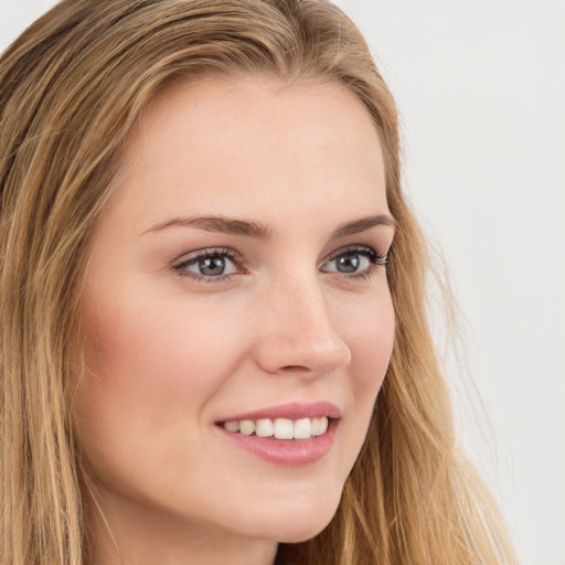 Joyful white young-adult female with long  brown hair and green eyes