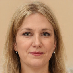 Joyful white adult female with long  brown hair and brown eyes