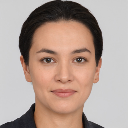 Joyful white young-adult female with short  black hair and brown eyes