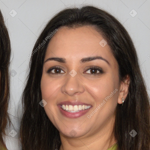 Joyful white young-adult female with long  brown hair and brown eyes