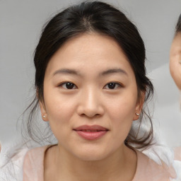 Joyful asian young-adult female with medium  brown hair and brown eyes