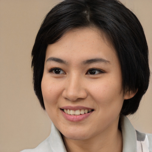 Joyful white young-adult female with medium  black hair and brown eyes