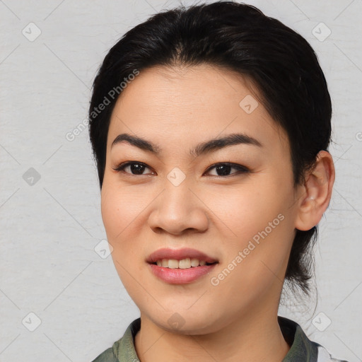 Joyful asian young-adult female with medium  black hair and brown eyes